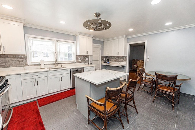 426 N High St, Mount Vernon, NY 10552 - kitchen with stainless steel appliances, a sink, crown molding, tasteful backsplash, and white cabinetry
