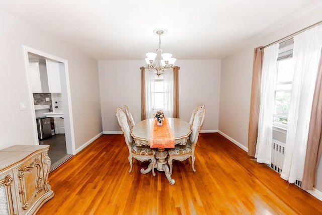 426 N High St, Mount Vernon, NY 10552 - dining room with a chandelier, healthy amount of natural light, radiator heating unit, and light wood-style floors