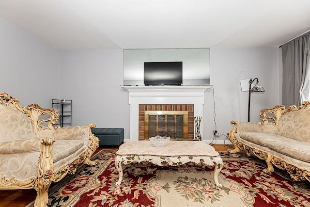 426 N High St, Mount Vernon, NY 10552 - living room featuring wood finished floors, a brick fireplace, and baseboards