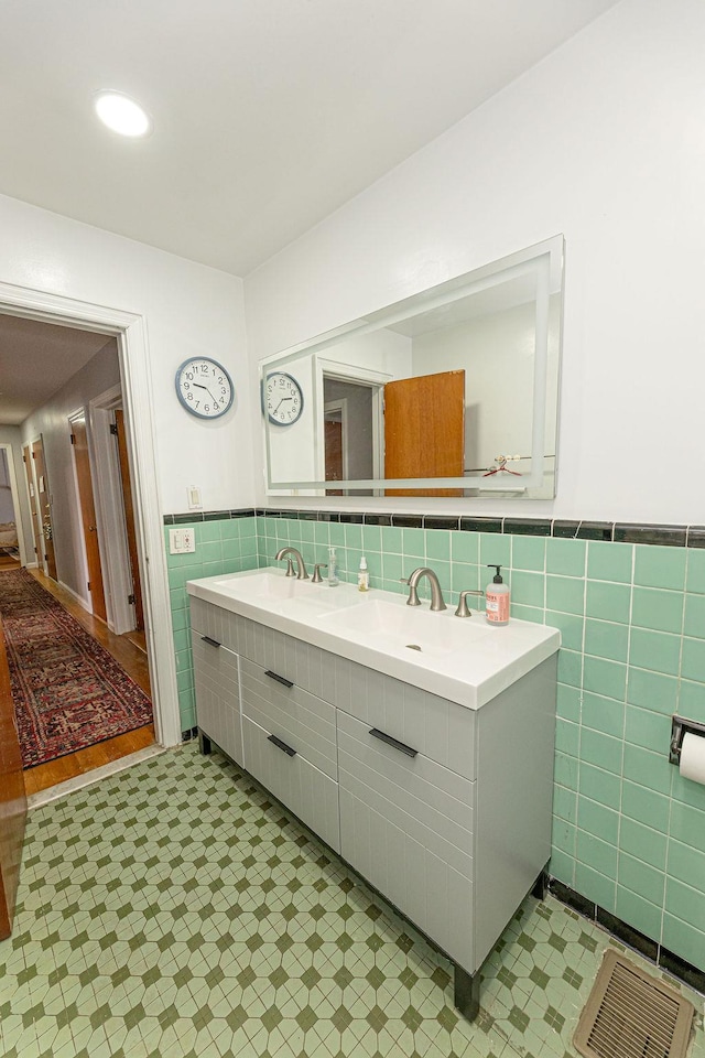 426 N High St, Mount Vernon, NY 10552 - bathroom with tile walls, double vanity, and a wainscoted wall