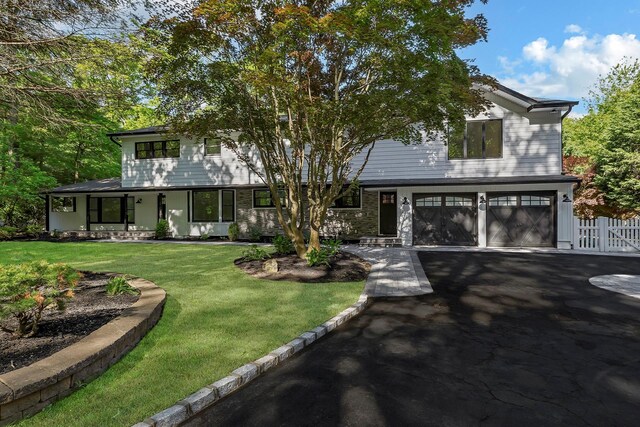 38 Cottontail Rd, Melville, NY 11747 - view of front of house with an attached garage and driveway