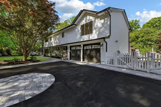 38 Cottontail Rd, Melville, NY 11747 - view of front of house featuring a garage and asphalt driveway