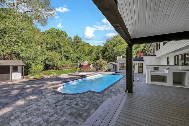 38 Cottontail Rd, Melville, NY 11747 - outdoor pool featuring an outbuilding, a bar, a patio area, an outdoor kitchen, and a wooden deck