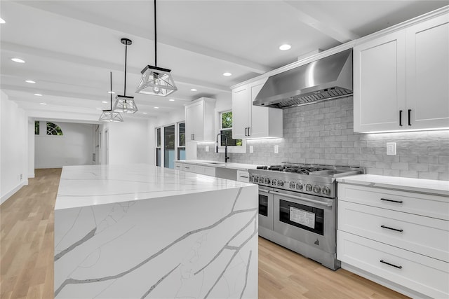 38 Cottontail Rd, Melville, NY 11747 - kitchen with range with two ovens, wall chimney range hood, backsplash, light wood-type flooring, and recessed lighting