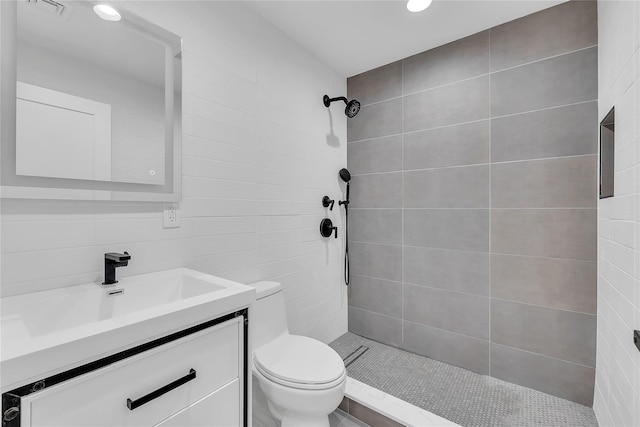 38 Cottontail Rd, Melville, NY 11747 - full bathroom featuring tile walls, a tile shower, toilet, vanity, and recessed lighting