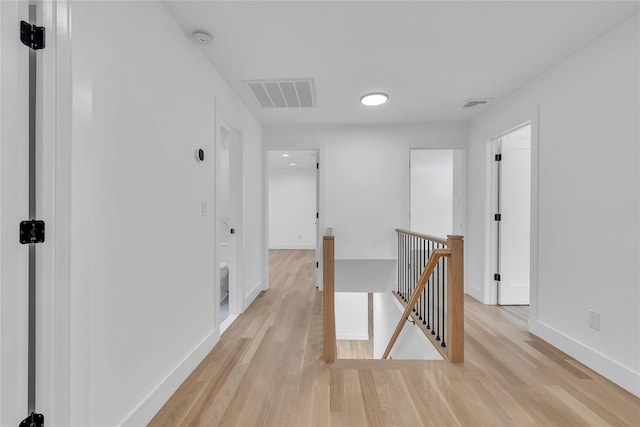 38 Cottontail Rd, Melville, NY 11747 - hallway with an upstairs landing, light wood finished floors, and baseboards