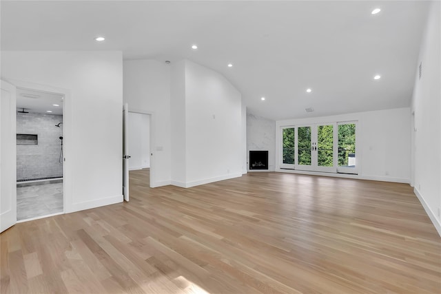 38 Cottontail Rd, Melville, NY 11747 - unfurnished living room featuring a high end fireplace, light wood-style floors, recessed lighting, baseboards, and high vaulted ceiling