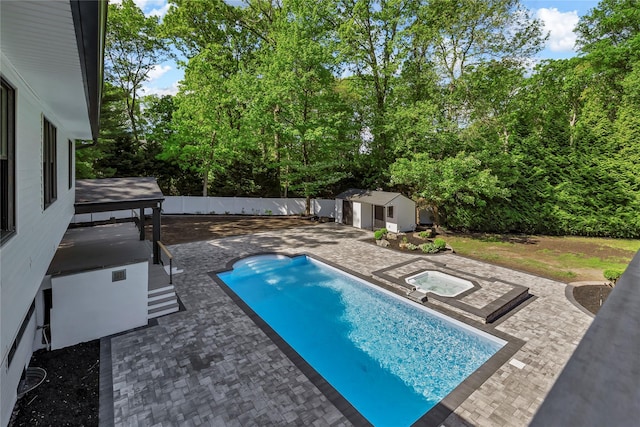 38 Cottontail Rd, Melville, NY 11747 - view of swimming pool featuring an in-ground hot tub, a patio area, a fenced backyard, and view of wooded area