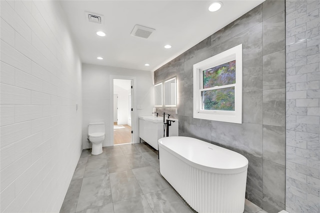 38 Cottontail Rd, Melville, NY 11747 - full bath featuring tile walls, vanity, a freestanding tub, toilet, and recessed lighting