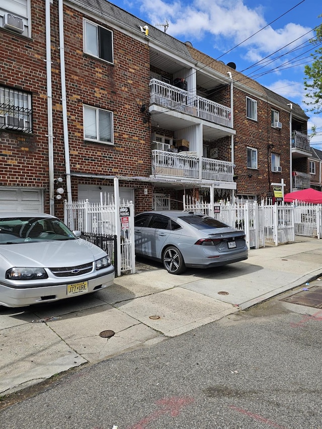 5824 Van Cleef St, Corona, NY 11368 - view of property featuring an attached garage, concrete driveway, and cooling unit