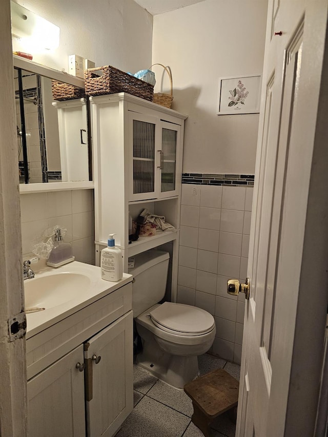 5824 Van Cleef St, Corona, NY 11368 - half bathroom featuring tile walls, toilet, vanity, and a wainscoted wall
