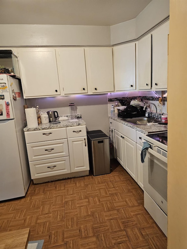 5824 Van Cleef St, Corona, NY 11368 - kitchen featuring white appliances, a sink, white cabinetry, and light stone counters