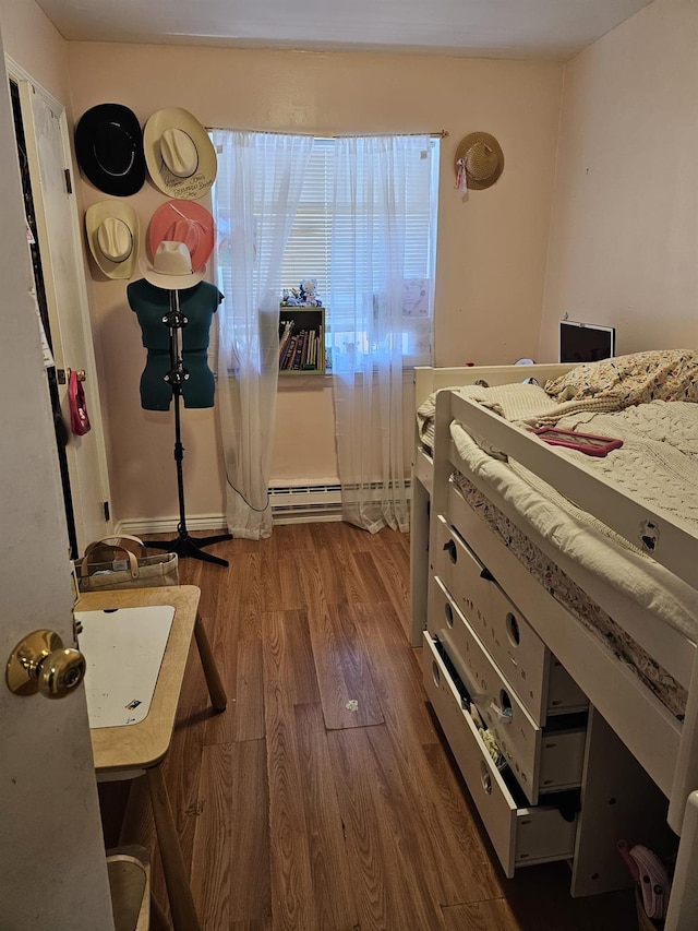 5824 Van Cleef St, Corona, NY 11368 - bedroom with dark wood finished floors and a baseboard heating unit