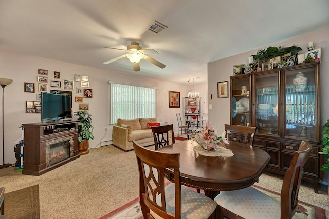 192 Ventry Ct Unit A, Ridge, NY 11961 - dining area featuring a ceiling fan, a baseboard radiator, light carpet, and a glass covered fireplace