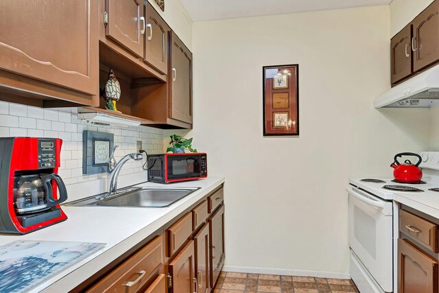 192 Ventry Ct Unit A, Ridge, NY 11961 - kitchen with white electric range, under cabinet range hood, baseboards, a sink, and backsplash