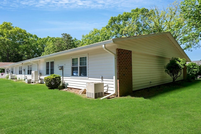 192 Ventry Ct Unit A, Ridge, NY 11961 - view of home's exterior with a lawn and central AC