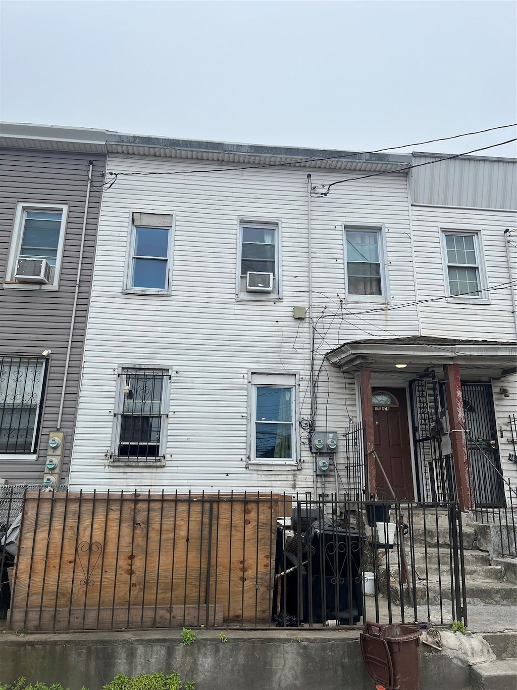 17008 Liberty Ave, Jamaica, NY 11433 - view of front of house with a fenced front yard and cooling unit