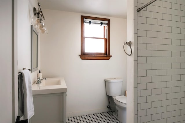 877 Shandelee Rd, Livingston Manor, NY 12758 - bathroom with toilet, vanity, a tile shower, tile patterned floors, and baseboards