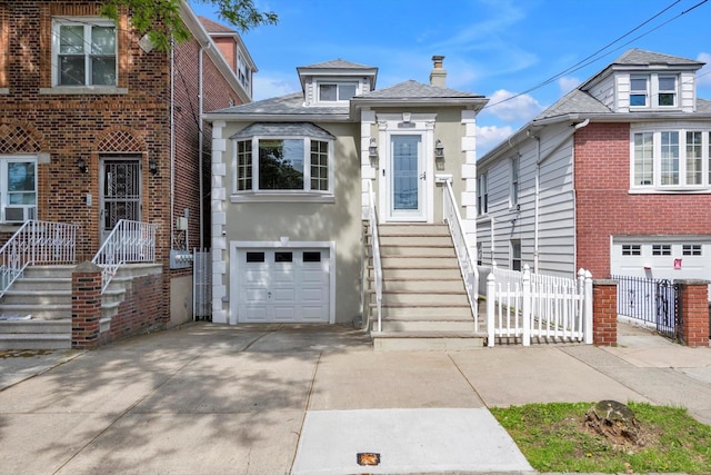 1627 Research Ave, Bronx, NY 10465 - view of front of home with an attached garage, driveway, stucco siding, a chimney, and cooling unit