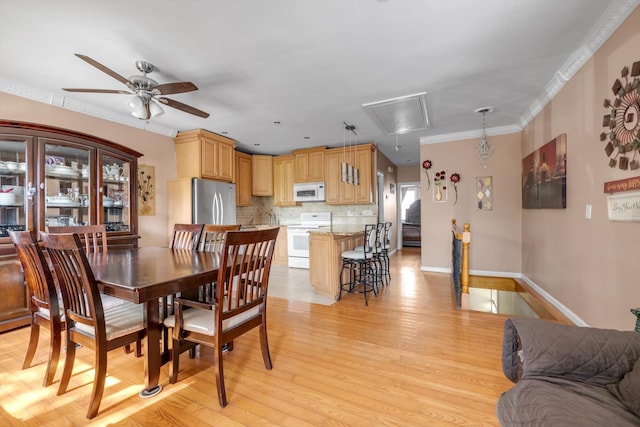 1627 Research Ave, Bronx, NY 10465 - dining area with attic access, ceiling fan, baseboards, ornamental molding, and light wood-style flooring