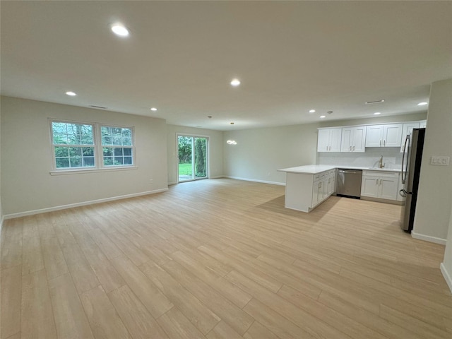 19 Erin Ln, East Setauket, NY 11733 - unfurnished living room with light wood-style flooring, recessed lighting, and baseboards