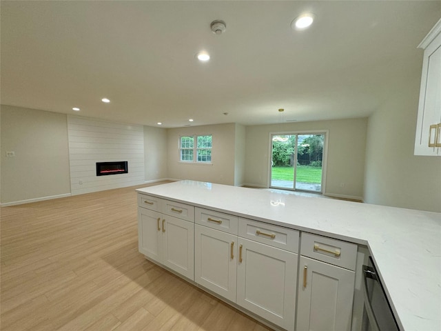 19 Erin Ln, East Setauket, NY 11733 - kitchen featuring open floor plan, light countertops, light wood finished floors, a fireplace, and recessed lighting