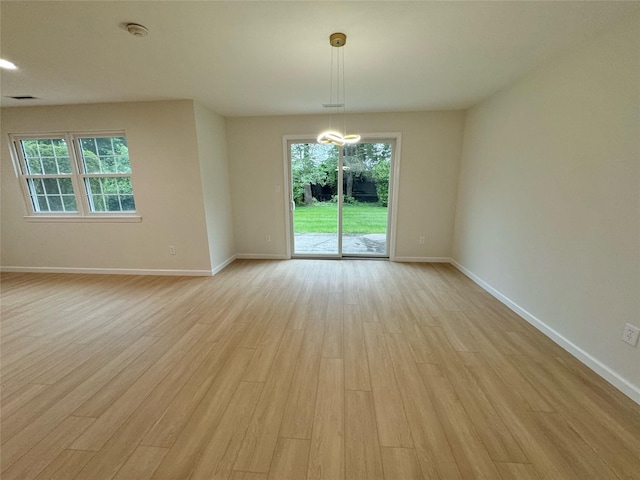 19 Erin Ln, East Setauket, NY 11733 - spare room with light wood finished floors, plenty of natural light, baseboards, and a smoke detector