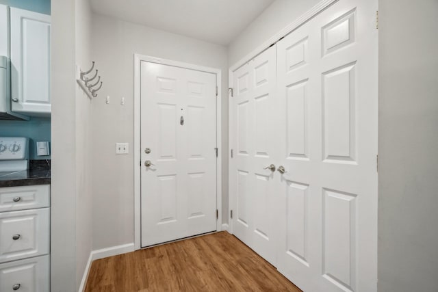 200 Woodcrest Ln Unit 202, Mount Kisco, NY 10549 - doorway to outside featuring light wood-type flooring and baseboards