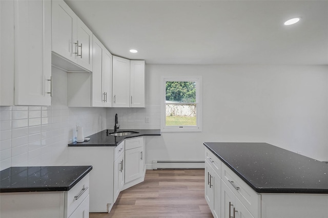 71 Cinnamon St, Central Islip, NY 11722 - kitchen featuring baseboard heating, a sink, light wood-style flooring, recessed lighting, and tasteful backsplash