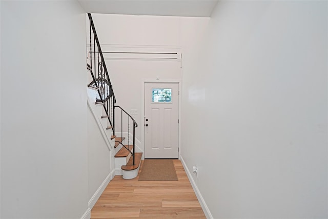 71 Cinnamon St, Central Islip, NY 11722 - doorway to outside with light wood-style floors, stairway, and baseboards