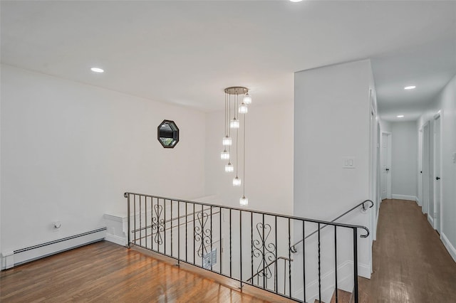 71 Cinnamon St, Central Islip, NY 11722 - hall featuring an upstairs landing, a baseboard heating unit, wood finished floors, recessed lighting, and baseboards