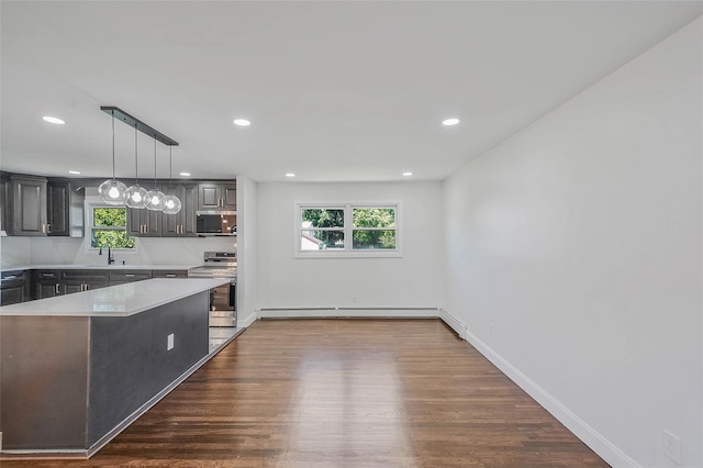 71 Cinnamon St, Central Islip, NY 11722 - kitchen featuring appliances with stainless steel finishes, a sink, light countertops, dark wood-type flooring, and recessed lighting