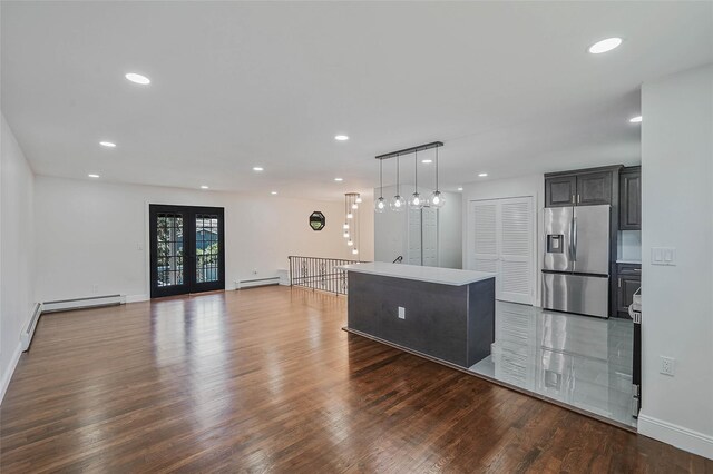 71 Cinnamon St, Central Islip, NY 11722 - unfurnished living room featuring baseboard heating, wood finished floors, baseboards, and recessed lighting