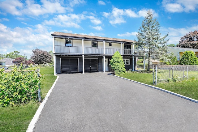 71 Cinnamon St, Central Islip, NY 11722 - view of front facade featuring asphalt driveway, an attached garage, and a balcony