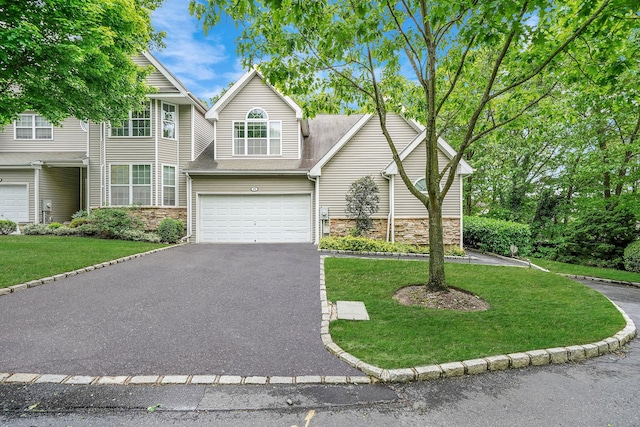 15 Arielle Ct, Hauppauge, NY 11749 - view of front of home featuring stone siding, asphalt driveway, a garage, a front yard, and roof with shingles