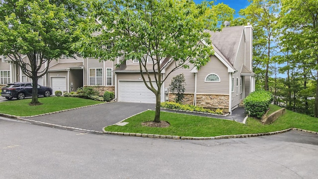15 Arielle Ct, Hauppauge, NY 11749 - view of front facade with a garage, stone siding, driveway, and a front lawn