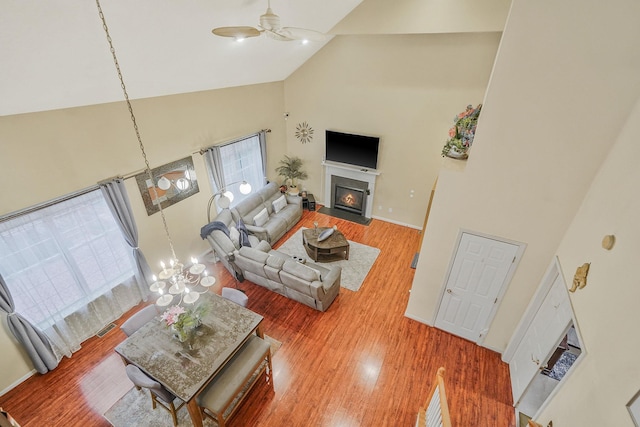 15 Arielle Ct, Hauppauge, NY 11749 - living room with high vaulted ceiling, ceiling fan, wood finished floors, and a fireplace with flush hearth