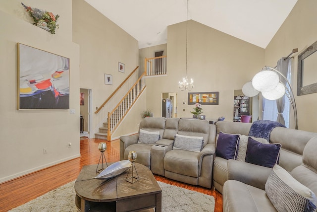 15 Arielle Ct, Hauppauge, NY 11749 - living area featuring wood finished floors, a chandelier, high vaulted ceiling, stairs, and baseboards