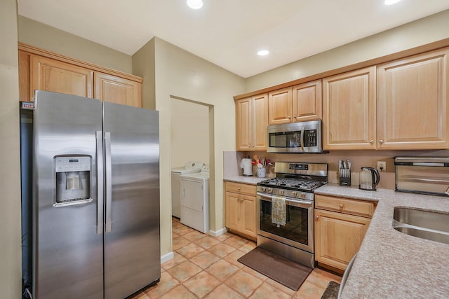 15 Arielle Ct, Hauppauge, NY 11749 - kitchen with appliances with stainless steel finishes, washing machine and clothes dryer, light brown cabinetry, light countertops, and a sink