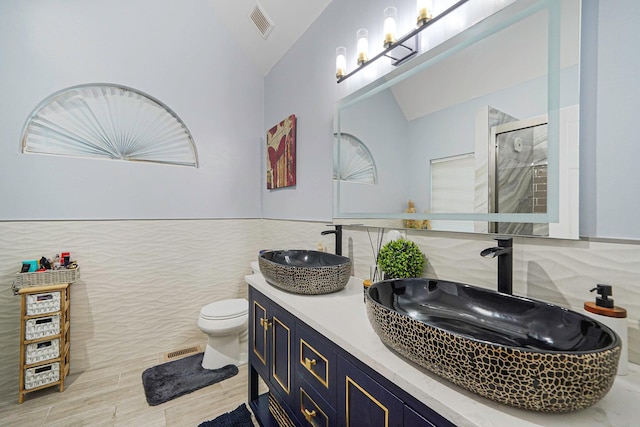 15 Arielle Ct, Hauppauge, NY 11749 - bathroom with lofted ceiling, tile walls, toilet, a shower stall, and double vanity