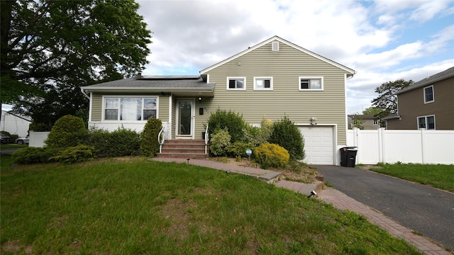 821 Virginia Ave, North Bellmore, NY 11710 - tri-level home featuring solar panels, driveway, a garage, and entry steps