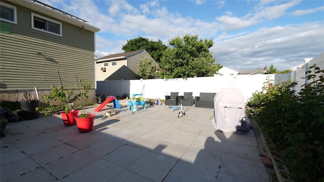 821 Virginia Ave, North Bellmore, NY 11710 - fenced backyard with a patio area