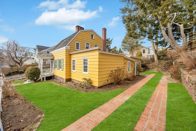 201 E Broadway Prt, Jefferson, NY 11777 - view of side of property with a chimney and a lawn