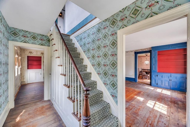 201 E Broadway Prt, Jefferson, NY 11777 - stairway featuring wallpapered walls, hardwood / wood-style floors, and baseboards