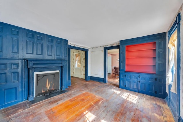 201 E Broadway Prt, Jefferson, NY 11777 - unfurnished living room with wood-type flooring and a fireplace with flush hearth