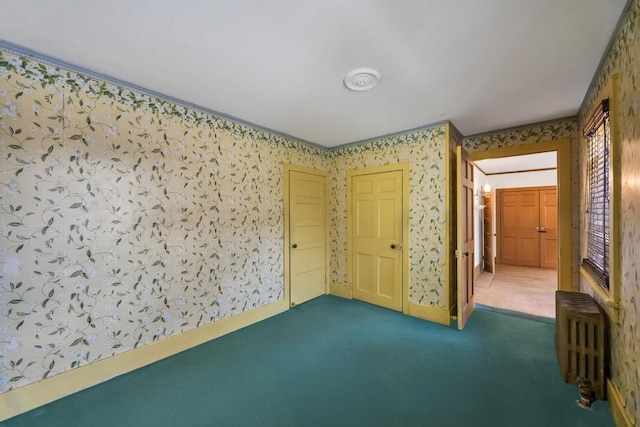 201 E Broadway Prt, Jefferson, NY 11777 - unfurnished bedroom featuring wallpapered walls, radiator, and carpet flooring