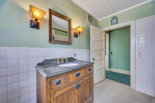 201 E Broadway Prt, Jefferson, NY 11777 - bathroom with tile walls, vanity, ornamental molding, a wainscoted wall, and tile patterned floors