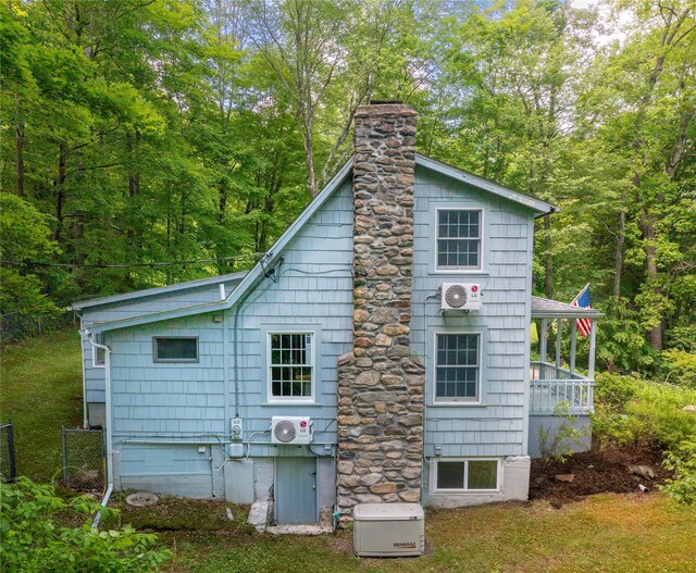 42 Harmony Rd, Pawling, NY 12564 - view of side of home with a chimney, a cooling unit, and a wooded view