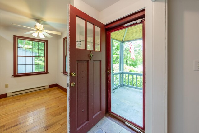 42 Harmony Rd, Pawling, NY 12564 - foyer featuring baseboard heating, plenty of natural light, ceiling fan, and light wood-style floors
