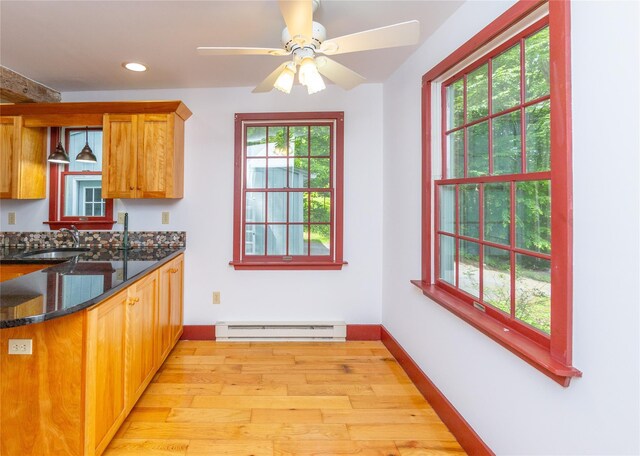 42 Harmony Rd, Pawling, NY 12564 - kitchen with baseboard heating, light wood-style floors, baseboards, recessed lighting, and dark stone countertops